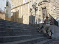 Met de fiets de trappen op bij de kathedraal van Cadz